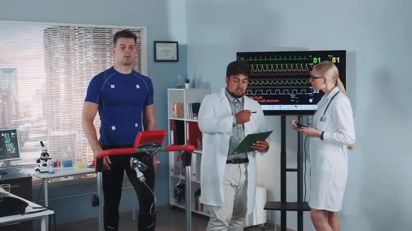 Diverse Cardiology Technologists Speaking About Athlete Fitness Level During the Stress Test on