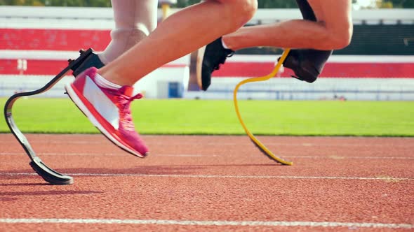 Close Up of Healthy and Prosthetic Legs While Running