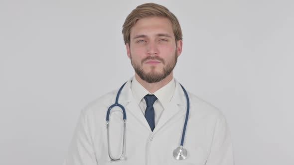 Serious Young Doctor on White Background