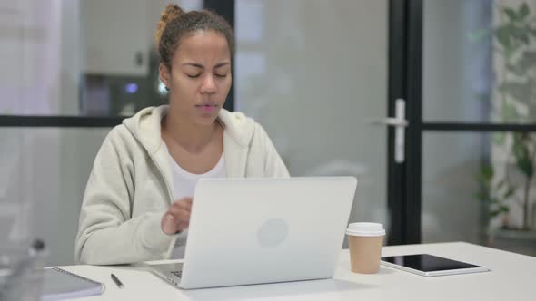 African Woman Having Headache While Working on Laptop