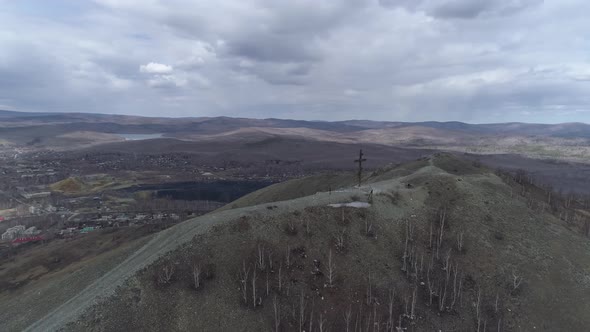 Aerial view of Orthodox cross on Mount Karabash and city 12