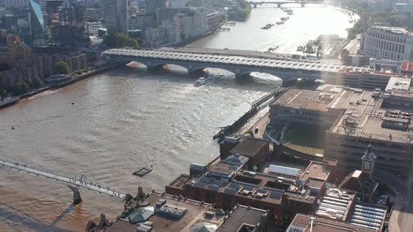 High Angle View of Buildings on Waterfront at Millennium Footbridge Across River Thames