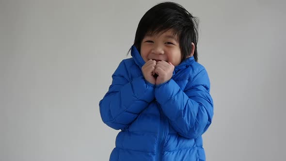 Happy Asian Child In  Blue Winter Clothes Standing Slow Motion