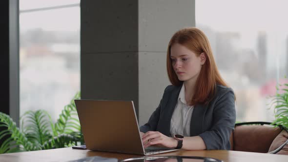 Successful Woman Boss is Working with Laptop in Modern Office Pretty Lady is Typing Message in Work