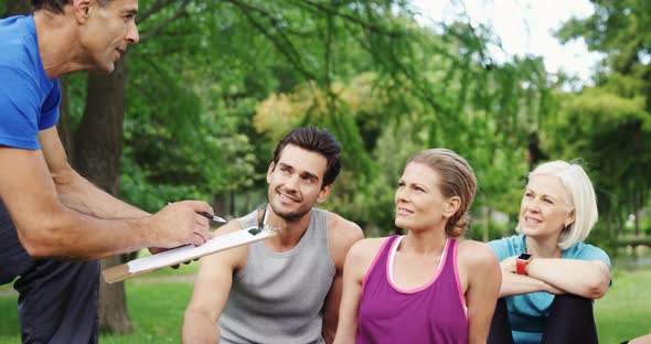 Group of people interacting with the trainer in the park