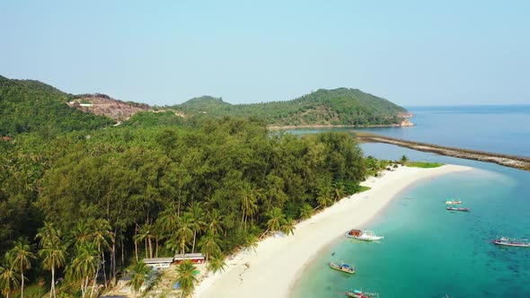 Aerial drone view landscape of beautiful shore beach vacation by blue water with bright sandy backgr