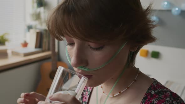 Girl Taking Pill and Drinking Water