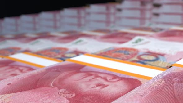 Many wads of money. 100 Chinese Yuan banknotes. Stacks of money.