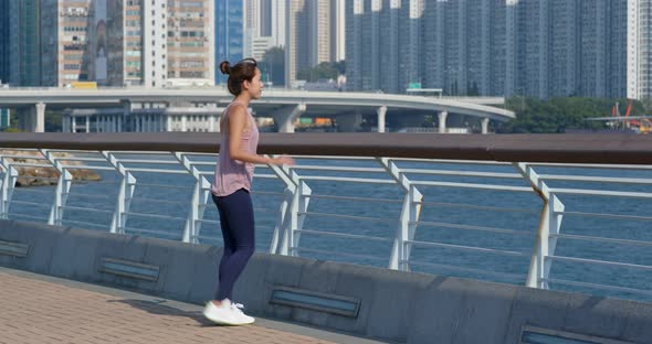 Woman stretch legs before running at outdoor