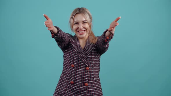 The Exalted Young Woman Energetically Transmits Hugs Through the Air to Everyone with a Wide Smile