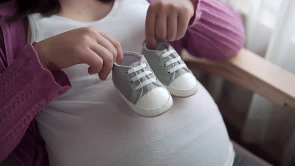 Happy Pregnant Woman and Expecting Baby at Home