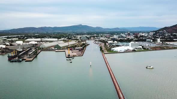 Drone flying above port / harbour moving toward city in the background. Location Townsville, Austral