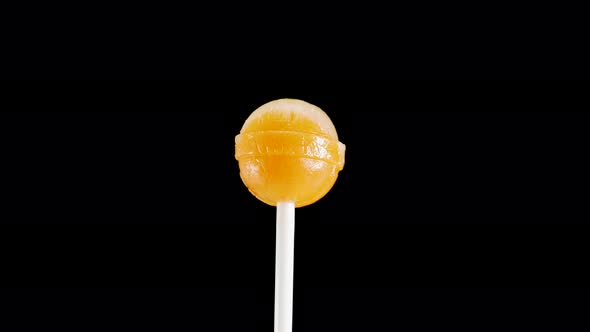 Appetizing Yellow Lollipop On A Black Background