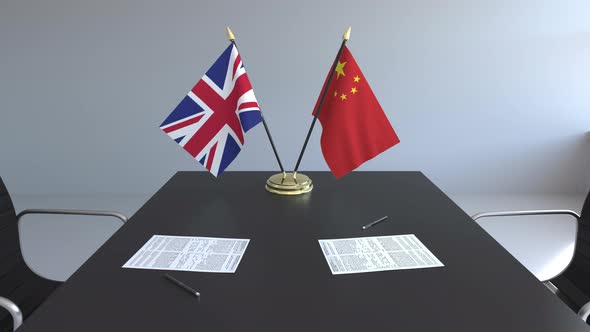 Flags of the UK and China on the Table alt