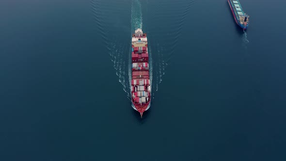 Aerial View of Ships with Numerous Containers Sailing on Calm Sea Waves