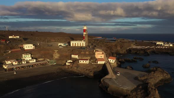 Majestic scenery of coast with beacon at sunset