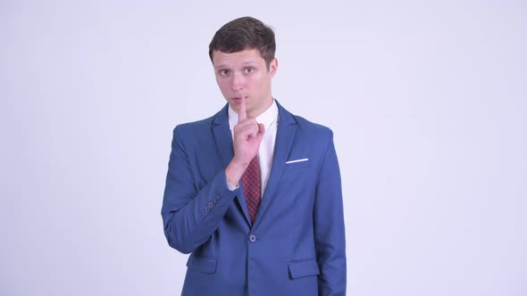 Young Handsome Businessman with Finger on Lips