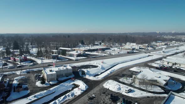 Aerial view of a snow covered town houses and streets on bright winter day