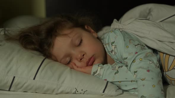 Cute Little Kid Girl Sleeping Well Alone in Bed