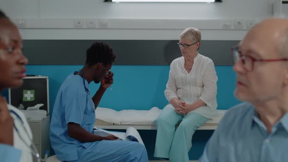 Senior Woman Receiving Medical Advice From Man Nurse