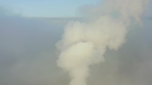 Smoke From a Power Station Chimney Rising From a Low Creeping Fog