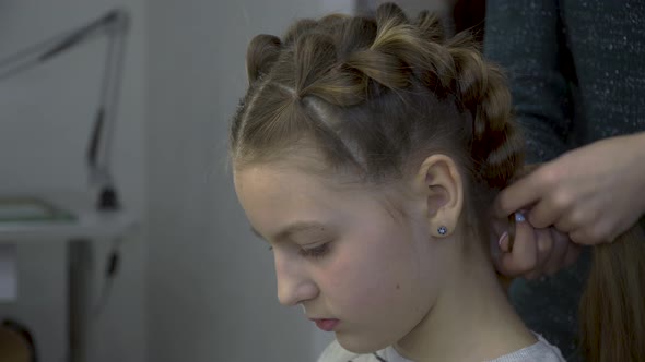 Hairdresser Makes Pigtails To a Girl