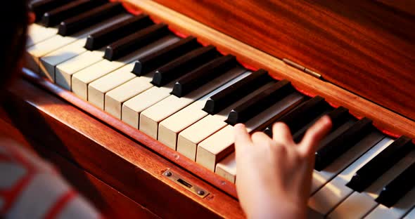 Schoolgirl learning piano in music class 4k