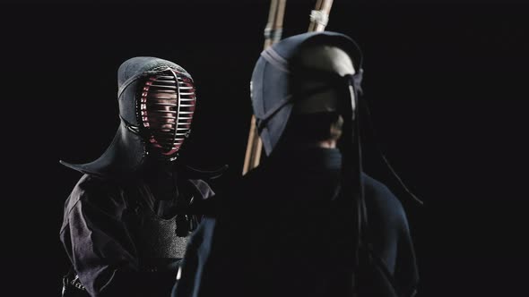 Kendo Fighters with Bamboo Swords on a Black Background