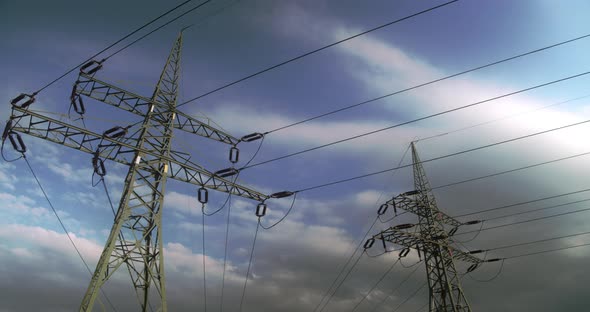 Timelapse. Floating clouds over high-voltage steel poles