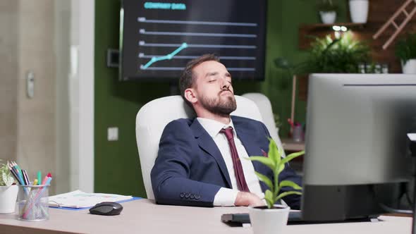 Tired Businessman Fell Asleep at His Workplace