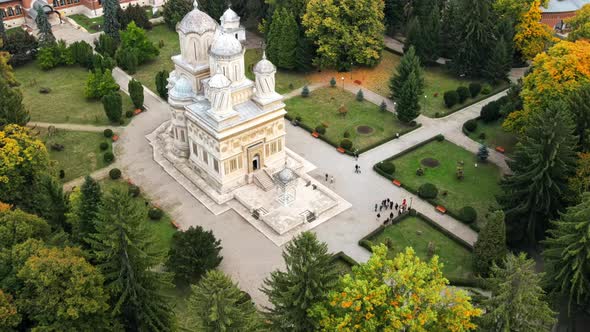 Aerial drone view of The Cathedral of Curtea de Arges, Romania. Square with greenery