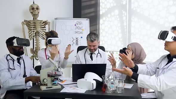 Doctor-Mentor Managing the Work of His Doctors-Interns which Wearing Virtual Reality Glasses