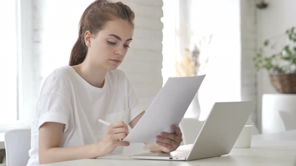 Young Woman Reading Documents, Paperwork