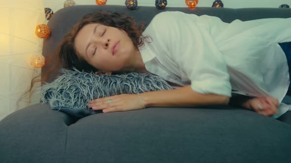 Exhausted Young Sleepy Woman Falls Down on Sofa