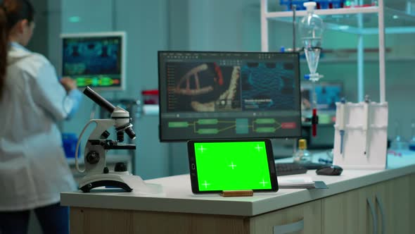 Notepad with Green Screen Working in Labooratory with Mock Up Monitor alt