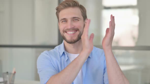 Portrait of Young Creative Man Clapping Applauding