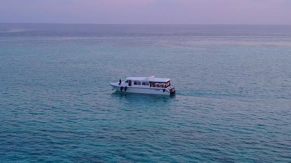 Boat off marine island beach wildlife by blue green ocean