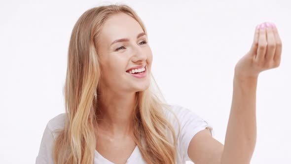 Young Beautiful Caucasian Blonde Girl Flirting Shying Waving and Covering Mouth with Hand on White