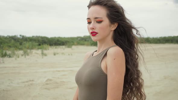 Pretty Woman Touching Hair on Beach