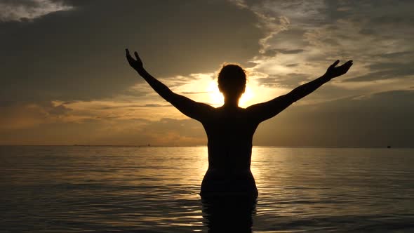 Free Happy Woman With Open Arms Enjoying Sunset In The Sea