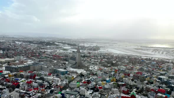 Aerial Panorama Of Reykjavík Cityscape Against Overcast Sky In Iceland.