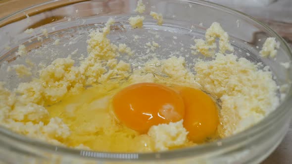 Add Two Raw Eggs to the Mixture and Beat with a Mixer in a Glass Bowl While Preparing the Dough for