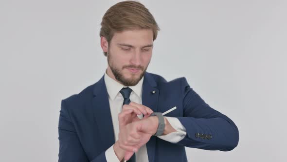 Young Businessman Using Smartwatch on White Background