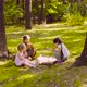 Three girls sitting in the park and eating pizza - VideoHive Item for Sale