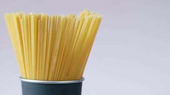 Yellow Long Spaghetti in a Container on Table