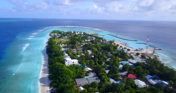 Wide angle fly over clean view of a white paradise beach and aqua turquoise water background in high