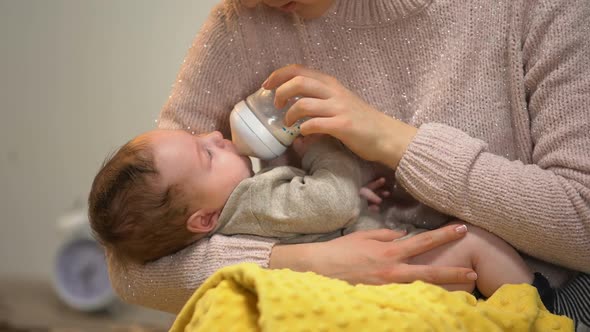 Babysitter Feeding Cute Little Child From Bottle, Artificial Feeding Accessories