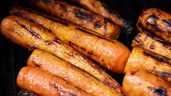 Cooking new carrots in charcoal grill