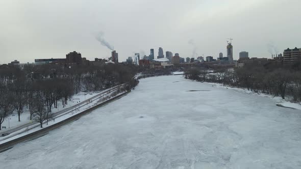 Mississippi River aerial footage over while completely frozen close to downtown minneapolis