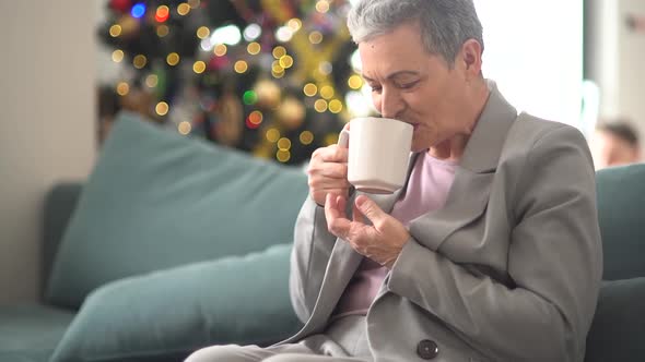Lonely Mature Woman Drinking Tea While Sitting on the Couch